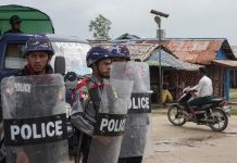 Rakhine State Police Transferred To Shan State Infected With COVID-19 Police stand guard at the Aung Mingalar IDP camp