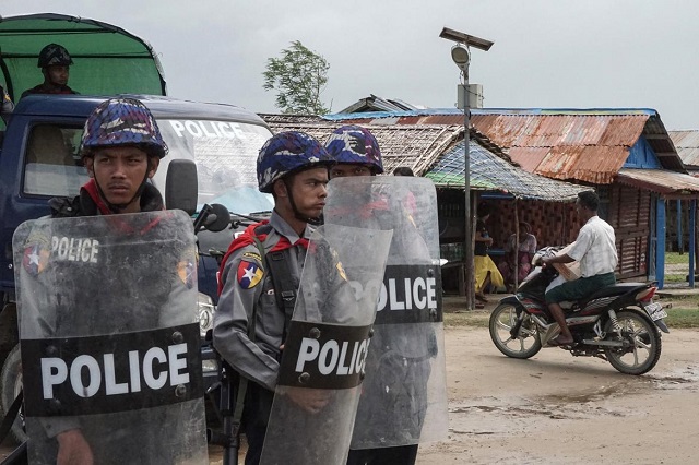 Police stand guard at the Aung Mingalar IDP camp