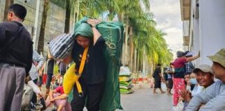 Women in Self-Employed Porter Labor Amidst Border Chaos A woman laboring as a porter