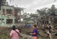 Junta Airstrike Hits Schools and Education Office in Hsenwi People have a look at damaged houses in Hsenwi
