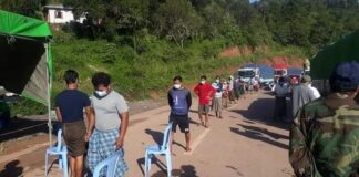 Woman Detained at Kalaw Checkpoint Over Alleged Links to Resistance Funding People line up at a checkpoint