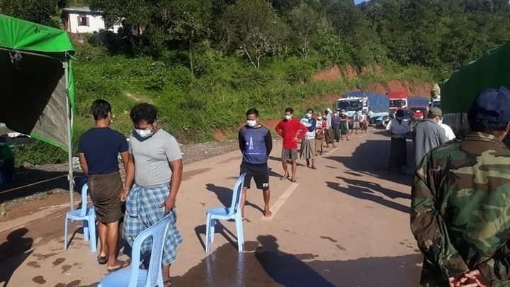 People line up at a checkpoint