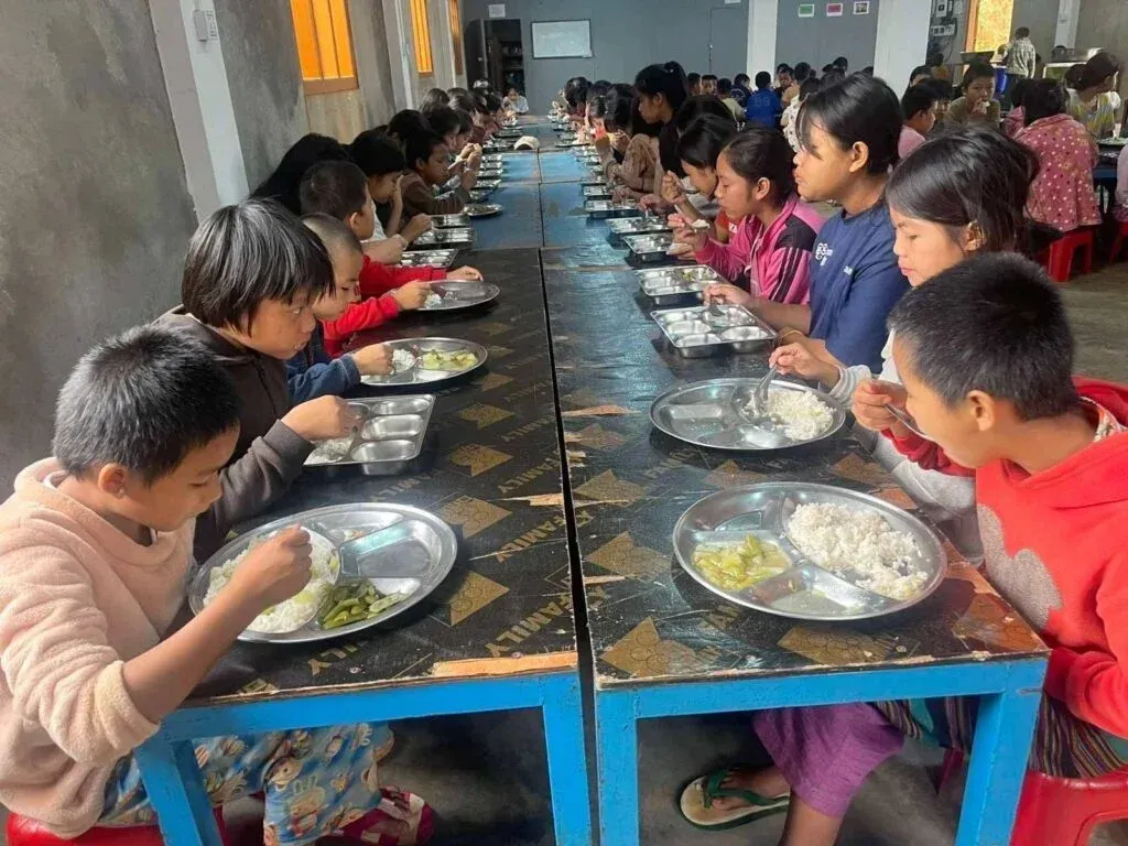 Displaced children at the school having a meal