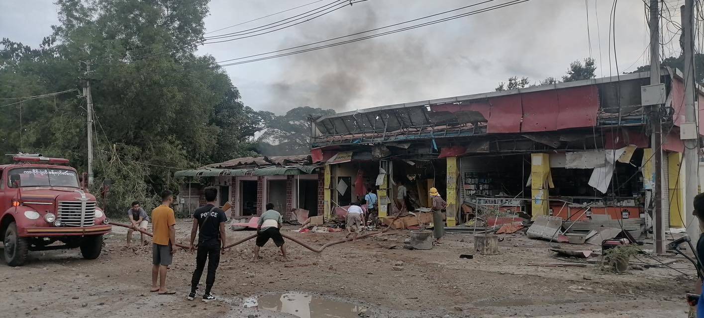 Residents help extinguish a fire after an airstrike in Hsipaw