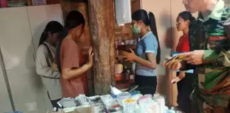 TNLA Accused of Forcing Early Tax Payments and Bribes from Namkham Shops A TNLA soldier seen at a drugstore