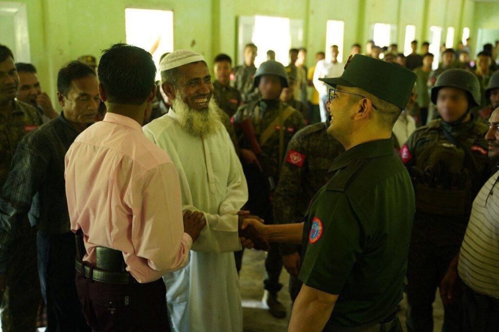 Gen Tun Myat Naing greets members of the Rohingya community