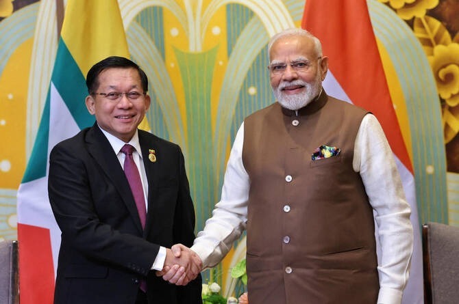 Min Aung Hlaing shakes hands with India’s Prime Minister Narendra Modi