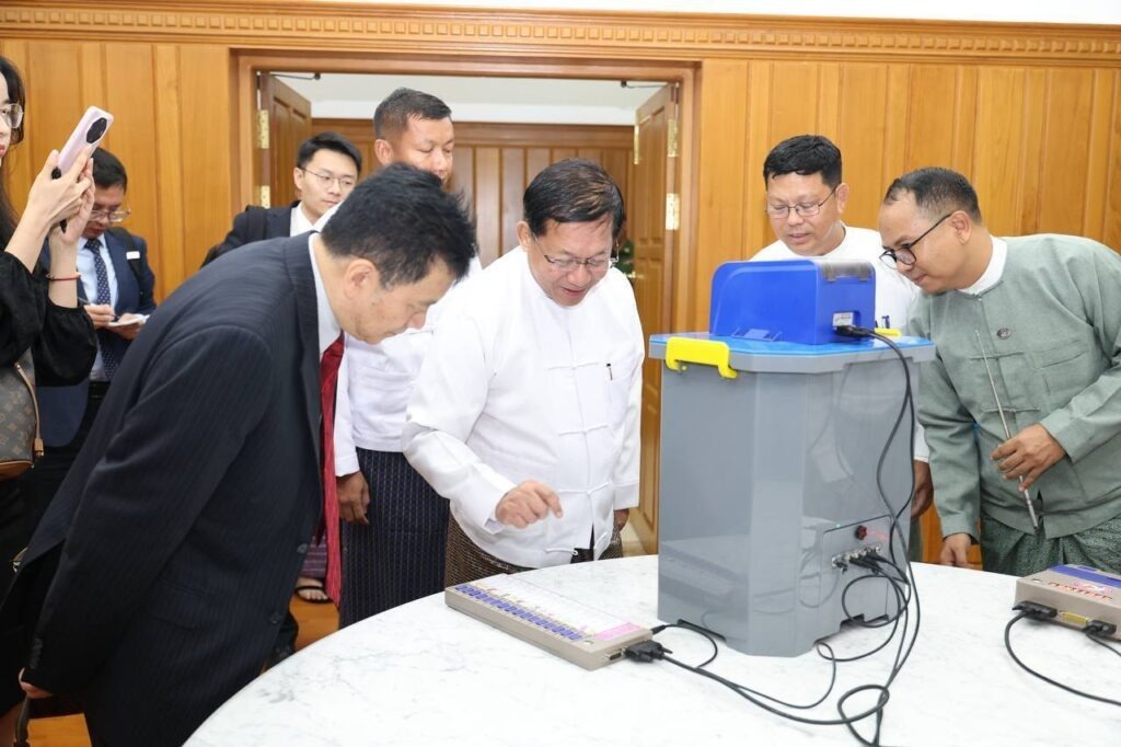 Min Aung Hlaing displays the regime’s electronic voting machine