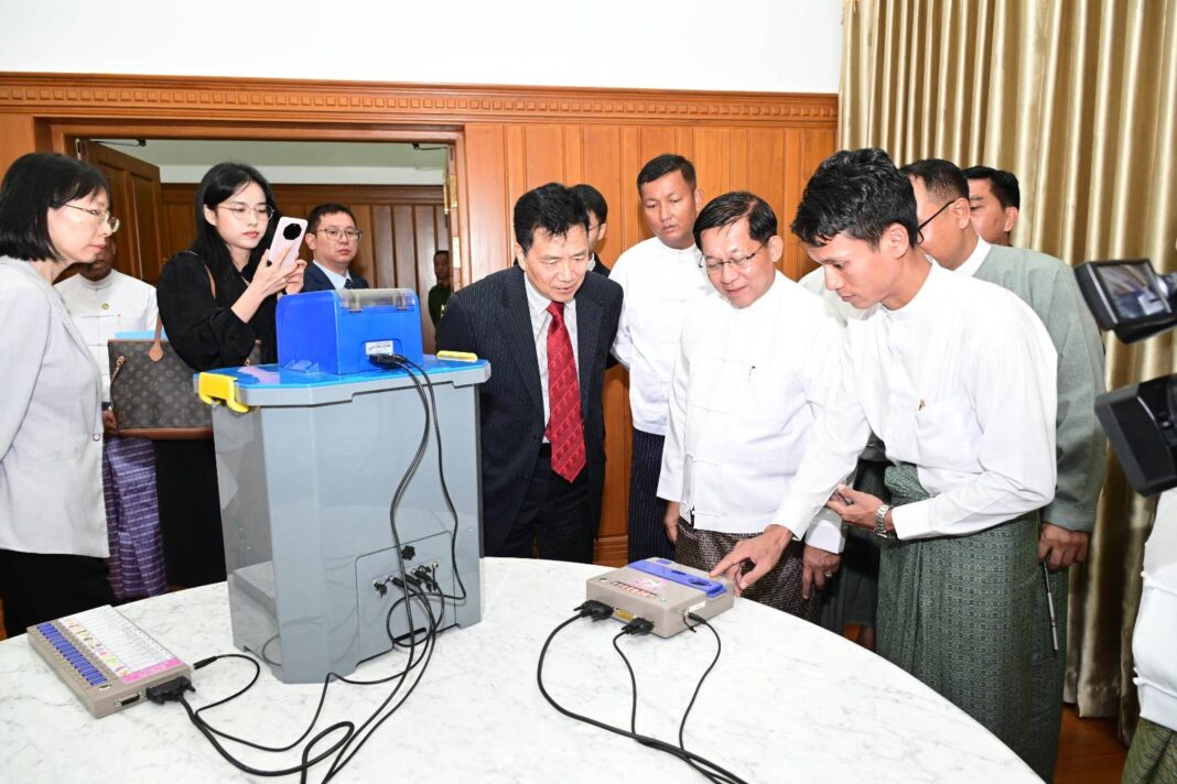 Min Aung Hlaing showcases the regime’s electronic voting machine Min Aung Hlaing showcases the regime’s electronic voting machine
