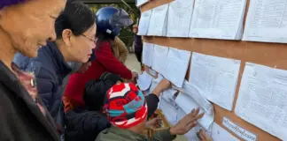 Low Voter Turnout Reported in Northern Shan State Amid Security Restrictions and Ongoing Conflict Residents check voter lists at a polling station in Northern Shan State