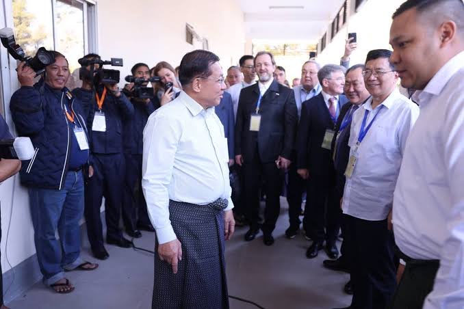 Deng Xijun is seen as monitoring observers