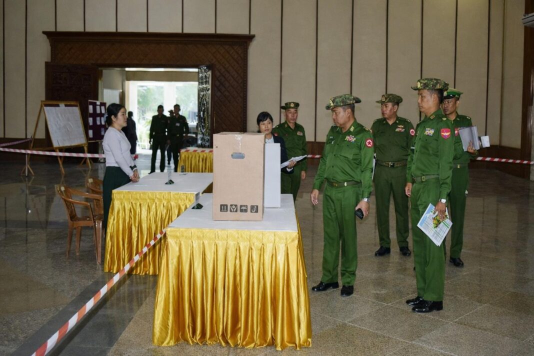 Military personnel inspect a polling station