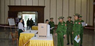 Fear and Repression Overshadow Phase Two of Junta Election Military personnel inspect a polling station