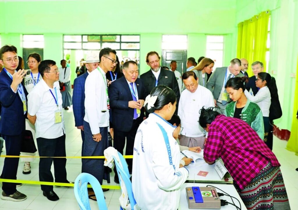 Foreign delegates observe voting at a polling station