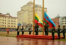 UWSA Tells Schools to Emphasize Burmese and Wa Languages Members of the United Wa State Army (UWSA) hoist a flag
