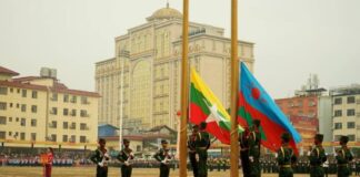 UWSA Tells Schools to Emphasize Burmese and Wa Languages Members of the United Wa State Army (UWSA) hoist a flag