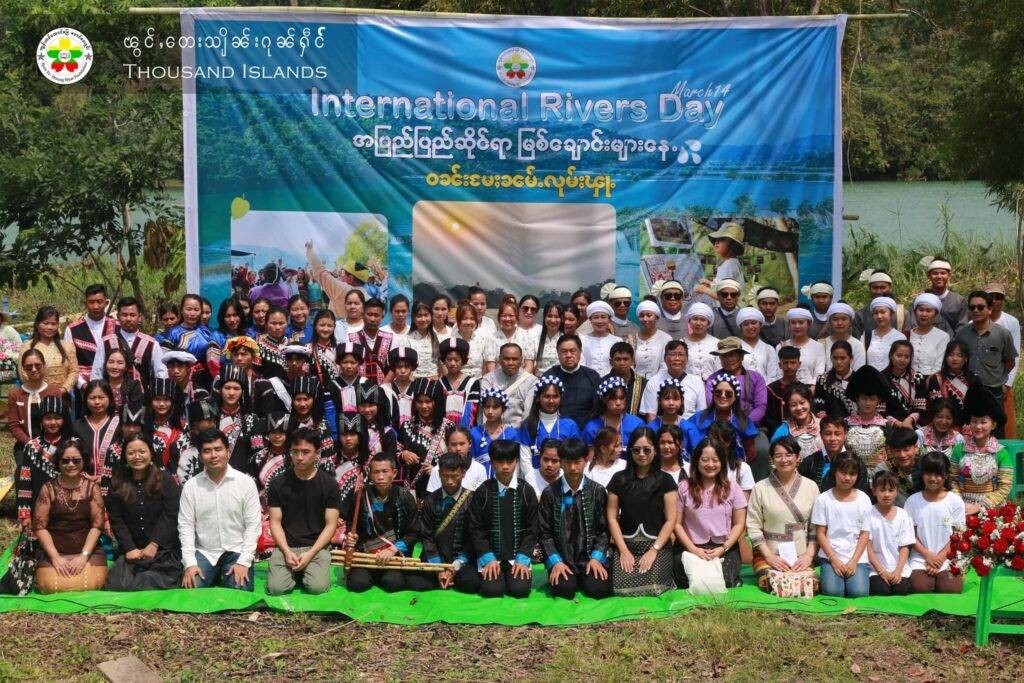 People gather for a group photo in observance of International River Day
