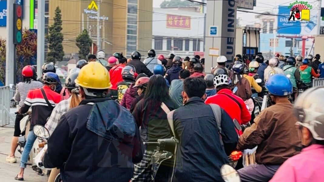 Residents line up to buy petrol at a fuel station amid ongoing fuel shortages