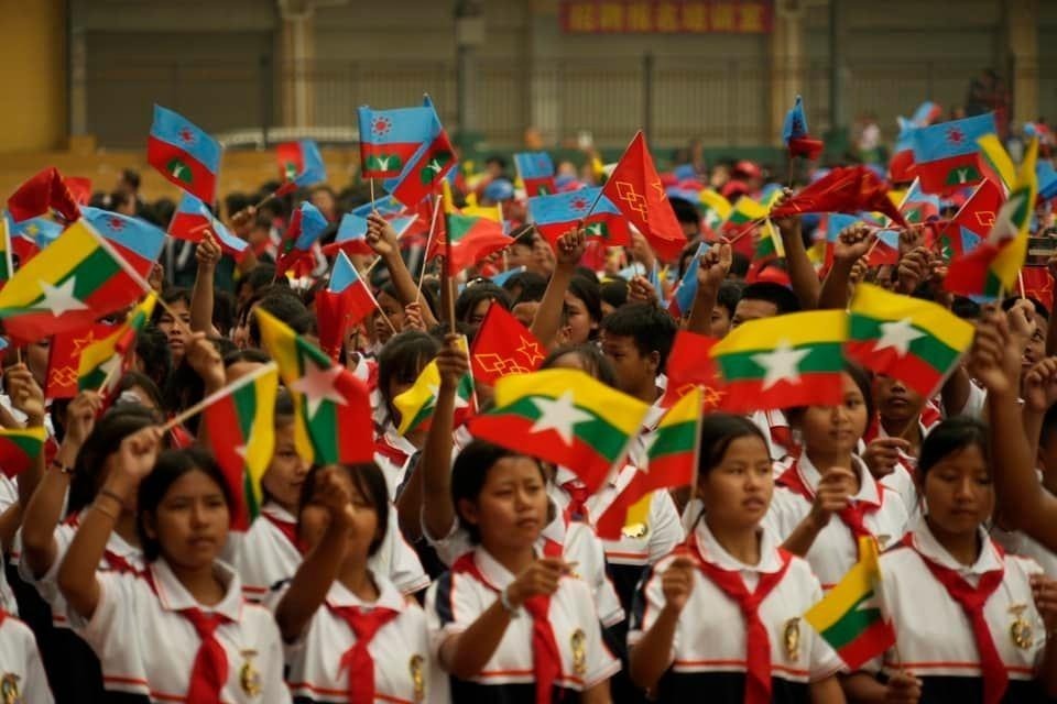 Young Wa children hold Myanmar and Wa flags