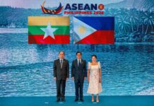 THE ASEAN’S 5PC IMPASSE: Why Benchmarks and Benchmarks Alone Cannot Force Compliance Myanmar's Permanent Secretary to ASEAN poses for a photo with Philippine President Ferdinand Marcos Jr and First Lady Louise Araneta Marcos during the ASEAN Summit in the Philippines