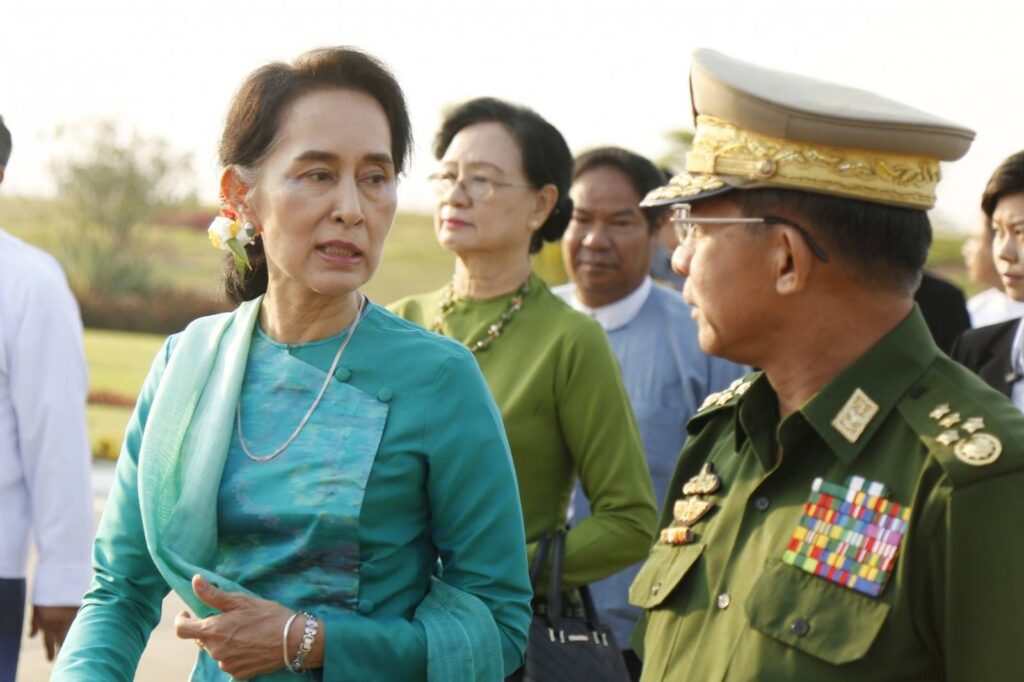 Myanmar's detained civilian leader Aung San Su Kyi is seen with coup leader Min Aung Hlaing prior to the military's attempted coup in 2021