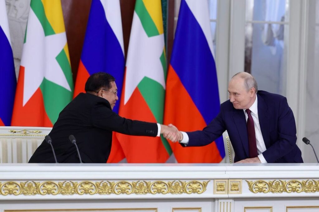 Myanmar junta chief Min Aung Hlaing shakes hands with Russian President Vladimir Putin during a meeting in Russia