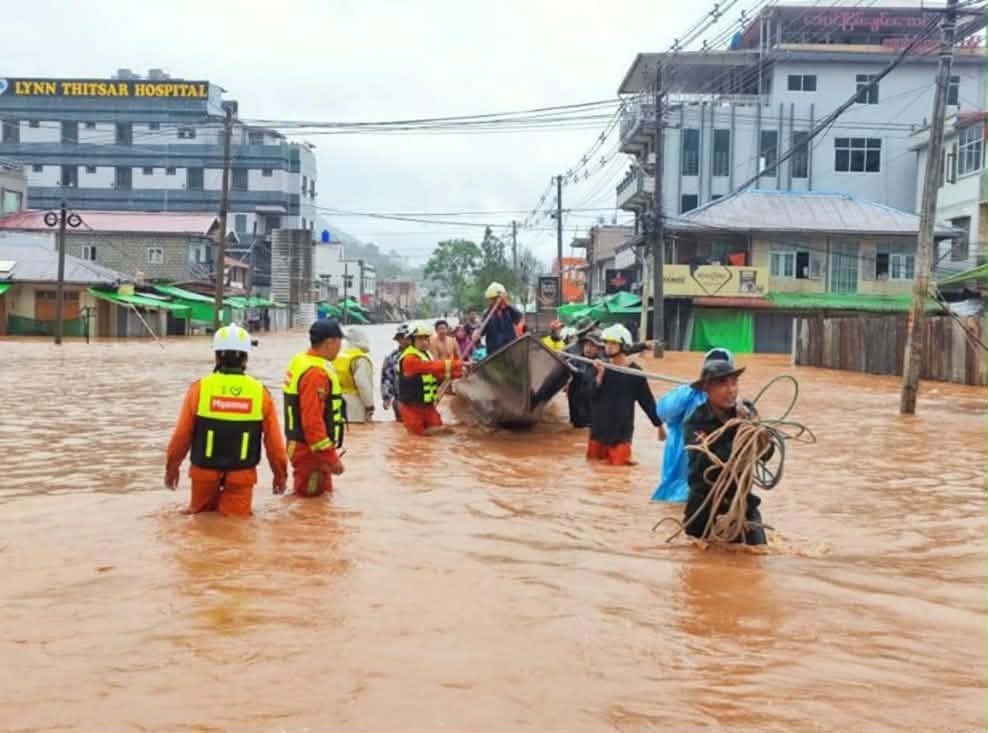 Rescue workers evacuate residents through floodwaters