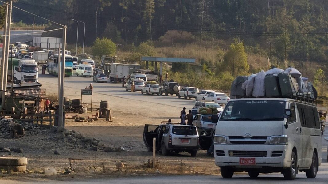 Vehicles queue along a road amid cargo inspections and checkpoints Vehicles queue along a road amid cargo inspections and checkpoints