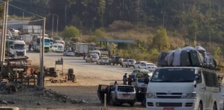 Trade Restrictions, Cargo Seizures Continue After Junta’s 100-Day Plan Ends Vehicles queue along a road amid cargo inspections and checkpoints
